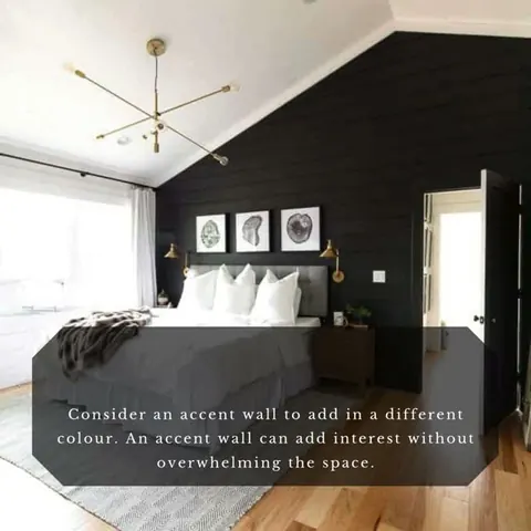 A bedroom with a black accent wall and the tip: consider an accent wall