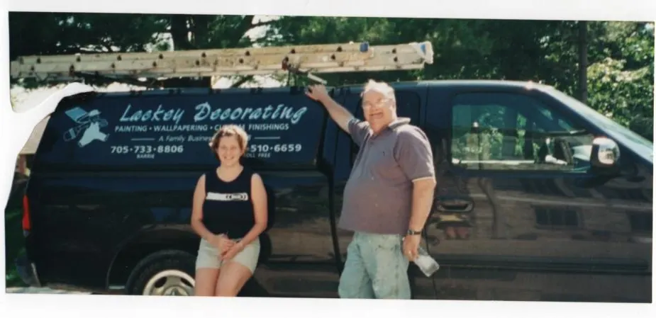 Tom Lackey and Melissa beside the Lackey Decorating work truck